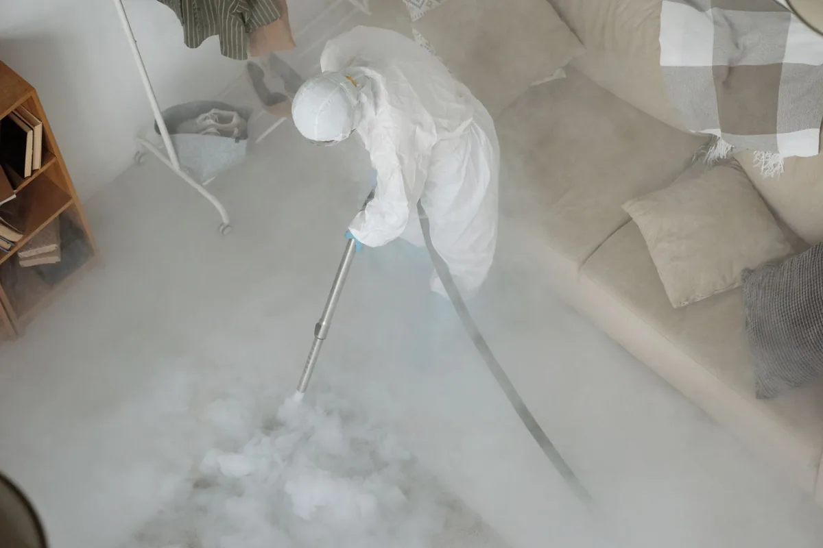 Biohazard cleanup technician in protective equipment, Pelican Bay, TX